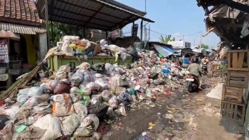Gunungan sampah hingga meluber menutup jalan di tempat pembuangan sampah Pasar Minggu (Foto : Darfan)